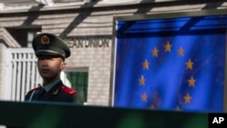 FILE - A Chinese paramilitary policeman stands guard at the entrance to the European Union Delegation to China compound in Beijing, China, Oct. 14, 2023. 