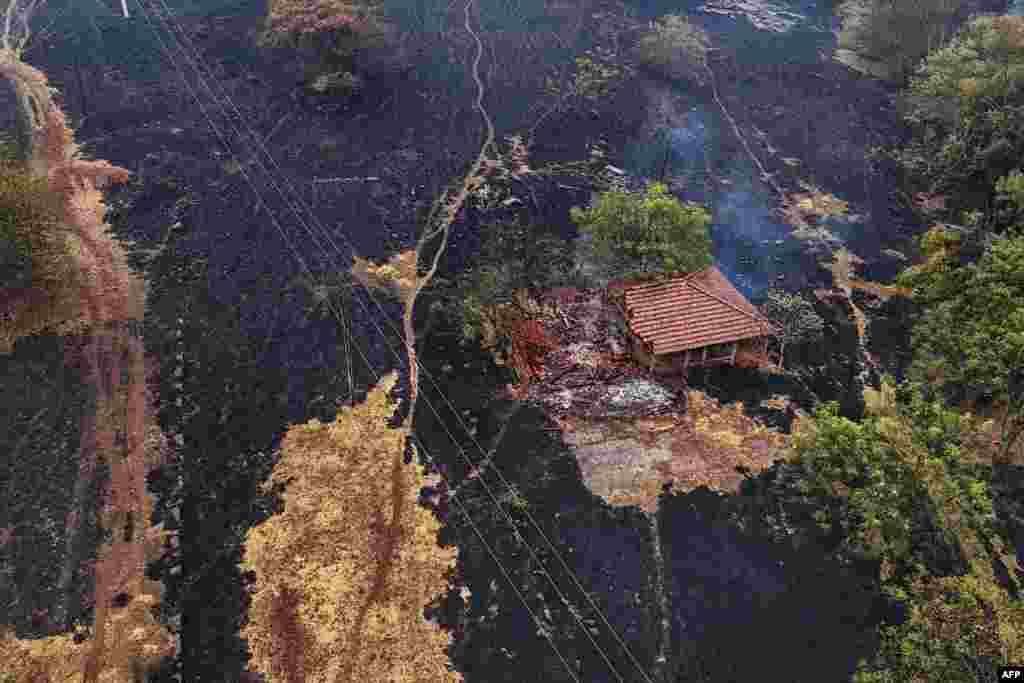 Aerial view shows a house destroyed by a fire in the surroundings of the SP-330 highway in Ribeirao Preto, Sao Paulo state, Brazil, Aug. 25, 2024. Forest fires in southeastern Brazil prompted a maximum alert to be declared in at least 30 cities in the state of Sao Paulo, where the fire blocked roads and smoke reached the capital Sao Paulo, according to local authorities.