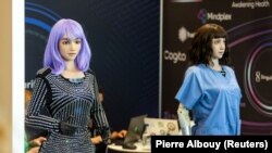 Humanoid robot 'Desmona' (left) is pictured at the U.N.'s "AI for Good Global Summit," in Geneva, Switzerland, July 6, 2023.