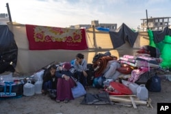 Palestinians displaced by the Israeli bombardment of the Gaza Strip gather at a tent camp, in Rafah, southern Gaza strip, Dec. 4, 2023.