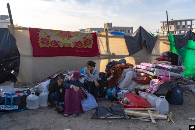 Palestinians displaced by the Israeli bombardment of the Gaza Strip gather at a tent camp, in Rafah, southern Gaza strip, Dec. 4, 2023.