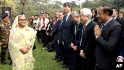In this photograph released by Bangladesh Prime Minister's office, Prime Minister Sheikh Hasina, left, arrives to address a press conference following her election victory in Dhaka, Bangladesh, Jan. 8, 2024.