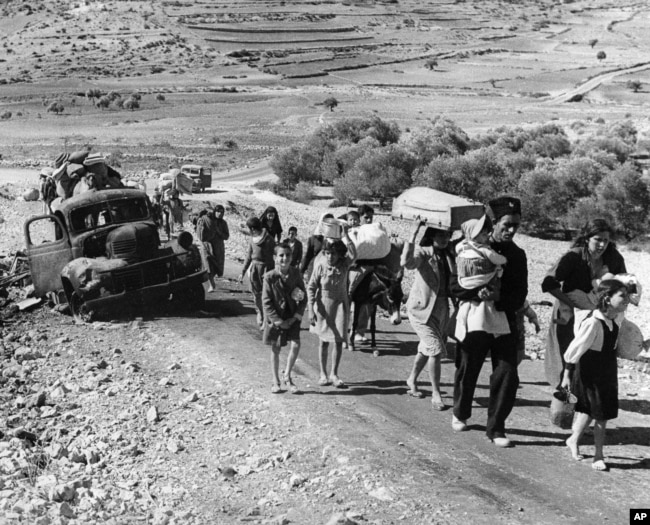 FILE - Arab refugees leave from Palestine on the Lebanon Road, Nov. 4, 1948, during fighting in Galilee between Israel and Arab troops. (AP/Jim Pringle)