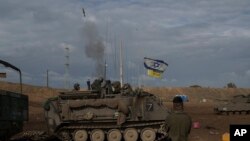 Israeli soldiers fire a mortar shell from southern Israel towards the Gaza Strip, in a position near the Israel-Gaza border, Jan. 3, 2024.