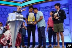 Dev Shah, 14, from Largo, Fla., celebrates winning the Scripps National Spelling Bee alongside his family, Thursday, June 1, 2023, in Oxon Hill, Md.