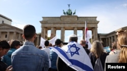 Supporters of Israel hold a solidarity rally in front of Brandenburg Gate, in Berlin, Germany, Oct. 8, 2023.