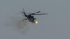 A Ukrainian military helicopter fires during drills in the north of Ukraine, June 1, 2023. 