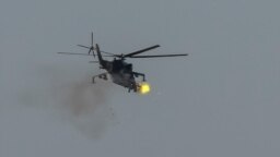 A Ukrainian military helicopter fires during drills in the north of Ukraine, June 1, 2023. 
