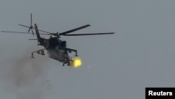 A Ukrainian military helicopter fires during drills in the north of Ukraine, June 1, 2023. 