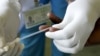 FILE - a counsellor, prepares to get a blood sample from a woman to test for HIV at the Mater Hospital in Kenya's capital Nairobi, September 10, 2015.