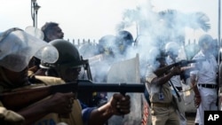 Police fire tear gas to disperse people protesting the rape and murder of a resident doctor at a government hospital earlier this month, in Kolkata, India, Aug. 27, 2024.