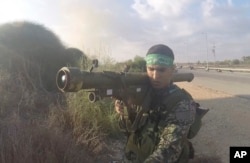 In this image from video taken Oct. 7, 2023, a Hamas fighter holds a Russian-designed 9M32 Strela anti-aircraft weapon. An Associated Press analysis of combat photos shows Hamas has amassed a patchwork arsenal of weapons from around the world.