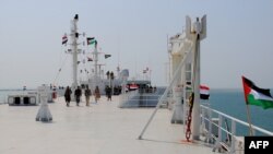 FILE - A picture taken during an organized tour by Yemen's Huthi rebels on November 22, 2023 shows the Galaxy Leader cargo ship, seized by Houthi fighters, docked in a port on the Red Sea in the Yemeni province of Hodeida, with Palestinian and Yemeni flags installed on it.
