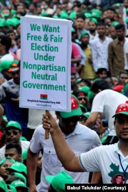 A demonstrator holds a poster at the BNP protest rally in Dhaka, Bangladesh, July 12, 2023, calling for a free and fair election.