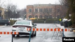 FILE - A police car patrols in a Jewish community in Montreal, Canada, March 30, 2020. A Jewish school in the city was reportedly hit by gunfire Sunday.