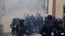 Police fire tear gas at a polling station after clashes erupted when electoral authorities delayed its opening to voters due to alleged electoral violations during general elections in San Jose El Golfo, outskirts of Guatemala City, June 25, 2023.