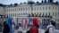People walk by election posters with the Presidential Palace in the background, in Helsinki, Finland, Jan. 27, 2024, ahead of the Finnish presidential election on Jan. 28.