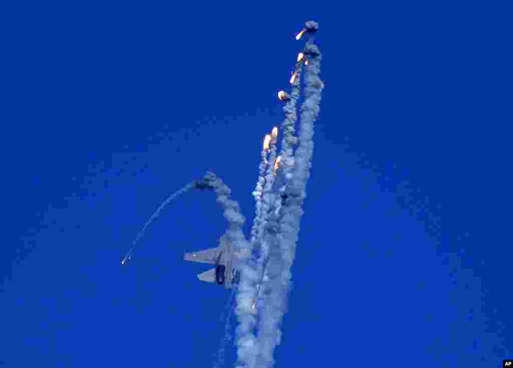 An Indian Air Force fighter aircraft Sukhoi Su-30 fires flares during Air Force Day celebrations at Sangam, the holy confluence of river Ganga, Yamuna and the mythical Saraswati, in Prayagraj.