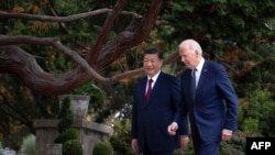 China's president Xi Jinping, left, talks with US. President Joe Biden after meeting in Woodside, California, on Nov. 15, 2023.