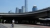 A man crosses the road near the central business district in Beijing, July 17, 2023. China's economy grew at a 6.3% annual pace in the April-June quarter, much lower than analysts had forecast given the slow pace of growth the year before. 