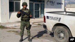 FILE - A Mexican army soldier guards the Tamaulipas State Prosecutor's headquarters in Matamoros, Mexico, March 8, 2023. Thirty-one migrants were abducted in the state Saturday.