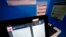 FILE - A touchscreen voting machine and printer are seen in a voting booth in Paulding, Georgia, Nov. 5, 2019.