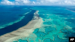 In this photo provided by the Great Barrier Reef Marine Park Authority the Hardy Reef is viewed from the air near the Whitsunday Islands, Australia, June 22, 2014. (Jumbo Aerial Photography/Great Barrier Reef Marine Park Authority via AP)