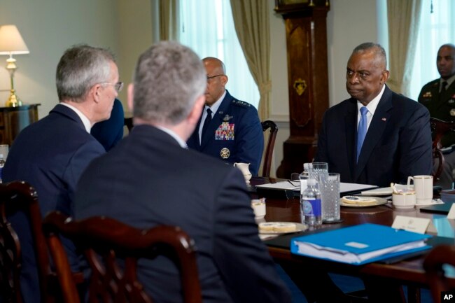 Defense Secretary Lloyd Austin, right, listens during a meeting with NATO Secretary General Jens Stoltenberg, left, at the Pentagon, near Washington, Jan. 29, 2024.