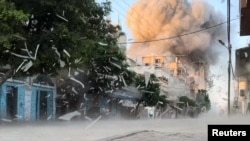 In this screenshot from a video dated August 18, 2024, smoke rises after an Israeli attack on a residential building in Nuseirat in the central Gaza Strip, amid the ongoing conflict between Israel and Hamas.