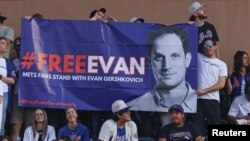 Fans at a New York Mets-New York Yankees baseball game at Citi Field display a banner in support of Wall Street Journal reporter Evan Gershkovich, who has been detained by authorities in Russia, June 13, 2023. (Vincent Carchietta-USA Today Sports)