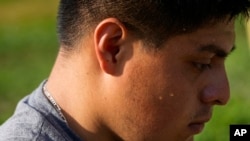 Sweat drips down the cheek of Brayan Manzano as he works, July 7, 2023, at a farm in Waverly, Ohio.