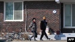South Korean residents walk through a village of Yeonpyeong island, near the 'northern limit line' sea boundary with North Korea, Jan. 6, 2024. 