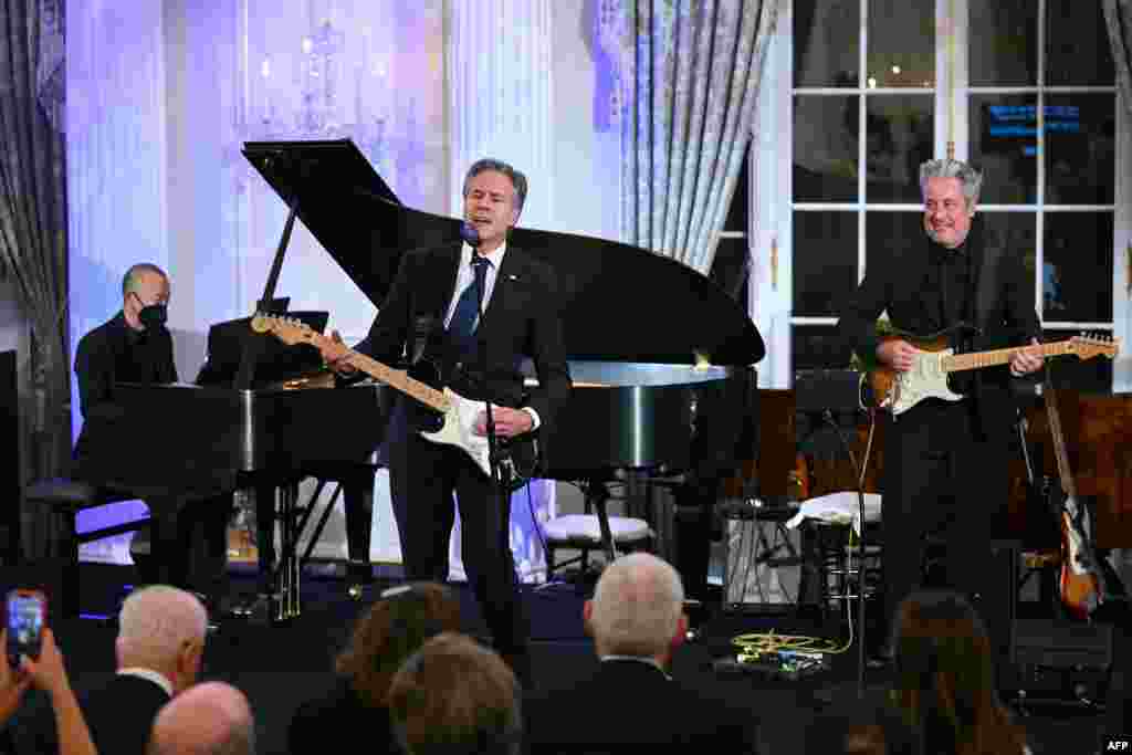 U.S. Secretary of State Antony Blinken performs a Muddy Waters song during a celebration marking the launch of the Music Diplomacy Initiative in the Benjamin Franklin Room of the State Department in Washington, Sept. 27, 2023.