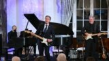 U.S. Secretary of State Antony Blinken performs a Muddy Waters song during a celebration marking the launch of the Music Diplomacy Initiative in the Benjamin Franklin Room of the State Department in Washington, Sept. 27, 2023.