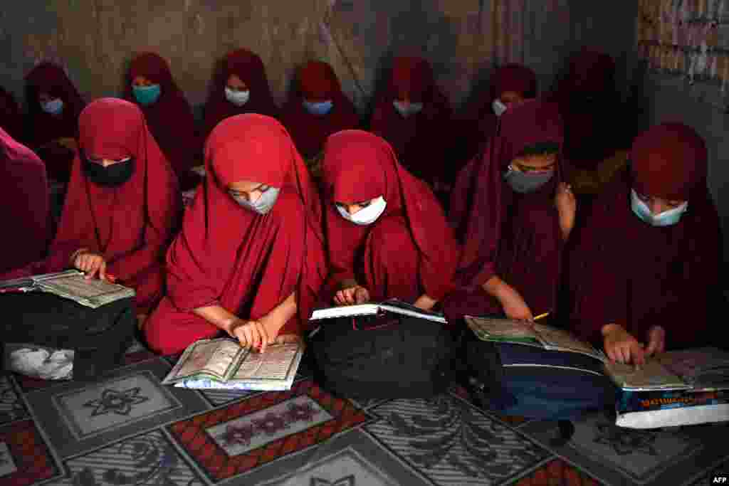 Afghan girls read the holy Quran at Madrassa Abdullah Bin Omar darul uloom (Islamic school) in Kandahar.