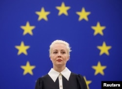 Yulia Navalnaya, the widow of Alexey Navalny, addresses the European Parliament, in Strasbourg, France, Feb. 28, 2024. She and other Navalny followers are asking Russians to flock to polling stations at noon Sunday to show their discontent with Putin.