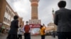 FILE - Tourists are seen in Urumqi, Xinjiang Uyghur Autonomous Region, April 21, 2021. Some U.S. lawmakers are demanding that seafood processed in two Chinese provinces be banned from entering the U.S. market on the grounds of rights abuse.