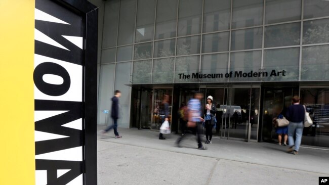 FILE — People walk the Museum of Modern Art in New York, April 22, 2014. A performer who appeared naked in a show at the museum is suing the museum, saying it failed to take action after he was sexually assaulted multiple times by attendees during the performances.