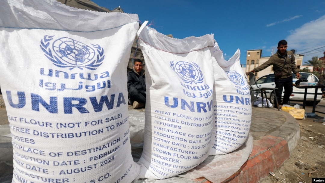 FILE - Displaced Palestinians wait to receive United Nations Relief and Works Agency (UNRWA) aid, amid the ongoing conflict between Israel and the Palestinian Islamist group Hamas, in Rafah, in the southern Gaza Strip, March 7, 2024. 