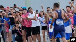 Fans cheer on El Salvador's Oscar Aldana in the men's athletics half marathon final during the Central American and Caribbean Games, in San Salvador, El Salvador, July 2, 2023.