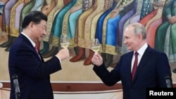 资料照片：俄罗斯总统普京和中国国家主席习近平在莫斯科克里姆林宫共同出席招待会。（2023年3月21日）