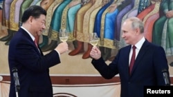 FILE - Chinese President Xi Jinping, left, and Russian President Vladimir Putin attend a reception at the Kremlin in Moscow, March 21, 2023. (Sputnik/Pavel Byrkin/Kremlin via Reuters)