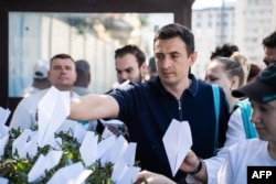 This handout photograph posted on the official Telegram channel of the Vice Speaker of the State Duma Andrei Davankov, Aug. 25, 2024, shows party supporters displaying paper planes outside France's Embassy in Moscow, in support of Pavel Durov, founder and CEO of Telegram.