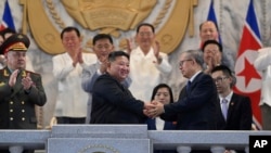 FILE - North Korean leader Kim Jong Un, center, shakes hands with China's Li Hongzhong, right, while Russia's Sergei Shoigu, left, looks on in Pyongyang, North Korea, July 27, 2023.
