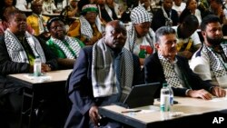 South African President Cyril Ramaphosa, first row left, listens in Johannesburg, Jan. 26, 2024 to the ruling from the top U.N. court that harshly criticized Israel's war against Hamas. 