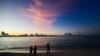 FILE - People walk along a beach at Vilimalé island in the the Maldives on Nov. 15, 2023. 