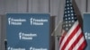 An undated photo focuses on a display of the Freedom House logo next to a U.S. flag.