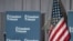 An undated photo focuses on a display of the Freedom House logo next to a U.S. flag.