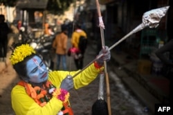 A devotee dressed as Hindu deity Lord Ram, poses for a picture in Ayodhya, India, on Jan. 22, 2024. India's Prime Minister Narendra Modi inaugurated a temple that embodies the triumph of his muscular Hindu nationalist politics.(Photo by Money SHARMA / AFP)