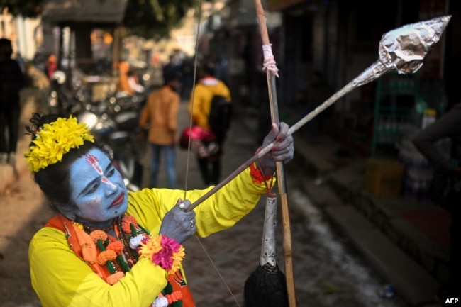 A devotee dressed as Hindu deity Lord Ram, poses for a picture in Ayodhya, India, on Jan. 22, 2024. India's Prime Minister Narendra Modi inaugurated a temple that embodies the triumph of his muscular Hindu nationalist politics.(Photo by Money SHARMA / AFP)